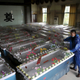 A mortuary worker prepares coffins after a cruise ship sank on the Yangtze River in Jianli, Hubei province, China, June 3, 2015. Scores of divers searched the capsized ship in the Yangtze River on Wednesday for more than 400 missing people, many of them elderly tourists, as the death toll in what could be China's worst shipping disaster in almost 70 years jumped to 18.